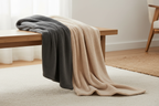 Soft sherpa throw blanket draped over a wooden bench in warm cozy interior